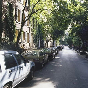 USA, New York, Manhattan, Greenwich Village, tree-lined street with cars parked on one side
