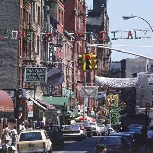 USA, New York, Manhattan, Lower East Side, busy street with Italian restaurants and shops, banner above reading Welcome to Little Italy