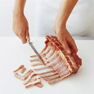 Using knife to remove strips of meat from ribcage