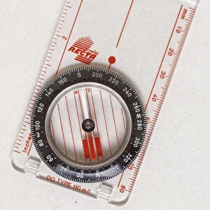 Above view of a magnetic compass the needle always points north and south because of the earths magnetic field