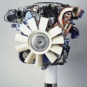 Front view of a V12 petrol engine with white fan at the front