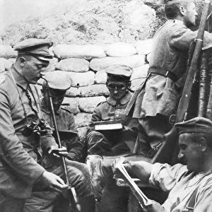 World War I: German soldiers reading, writing and smoking in the trenches during