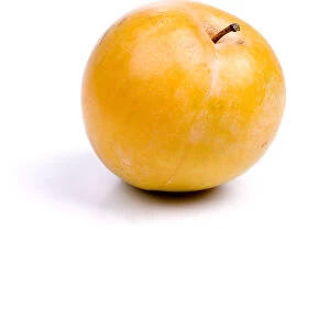 Yellow plum against white background
