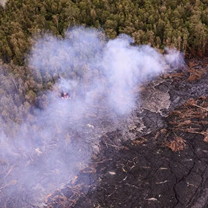 Aerial view of lava from Mauna Loa and burning forest, Big Island, Hawaii, USA
