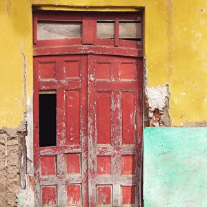 Colorful facade and red door at old colonial house in Granada, Nicaragua