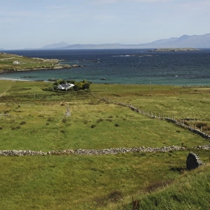 green fields and stone walls on inishbofin island off the coast in connacht region