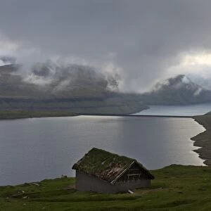 Hut at Eidisvatn lake, low clouds, Eysturoy, Faroe Islands, Denmark