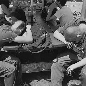 Men sleeping on picnic table