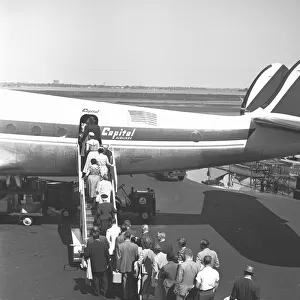 People boarding on airplane, (rear view), (B&W), elevated view