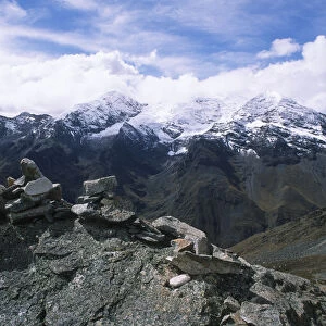 Stone Cairn with Snow-Capped Mountains in the Background