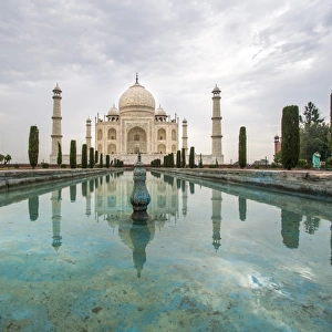 Taj Mahal at sunrise with reflection in pool