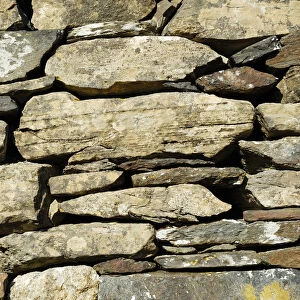 Wall of the historic early christian Saint Columcille abbey, constructed from piled up stones, Co Donegal Ireland