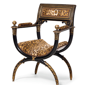 A Directory curule armchair, c. 1795 (ebonised & gilded wood with leopard print upholstery