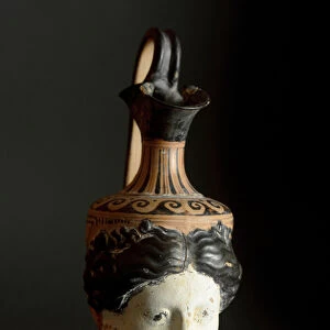 Etruscan antiquite: terracotta oinochoe in the shape of a feminine head. From Vulci