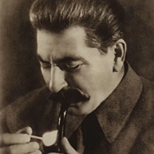 Soviet leader Joseph Stalin lighting his pipe, 1936 (b / w photo)