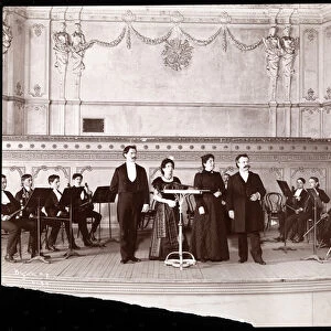 String section behind male and female vocalists, 1905 (silver gelatin print)