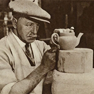 Worker producing a teapot at the Royal Doulton works, Stoke-on-Trent, Staffordshire (b / w photo)