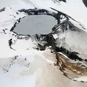 Aerial view of snow-covered Ruapehu volcano summit crater with acidic lake, New Zealand