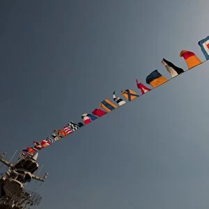 Flags fly over the deck of the USS Iwo Jima