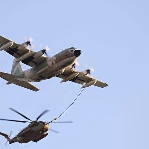 An Israeli Air Force KC-130H Karnaf refuels a CH-53 Yasur helicopter