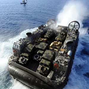 A Landing Craft Air Cushion exits the well deck of USS Bataan