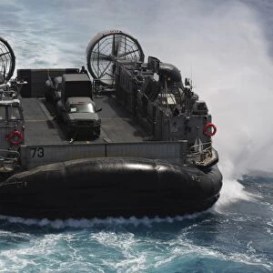 A Landing Craft Air Cushion prepares to enter the well deck of USS Essex