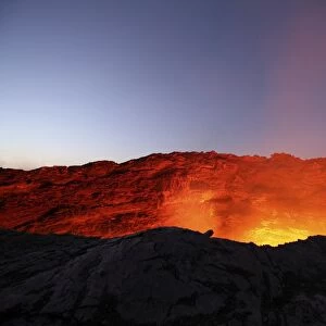 Lava lake illuminating walls of pit crater at night, Erta Ale volcano, Danakil Depression