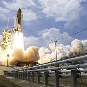 Space Shuttle Atlantis lifts off from its launch pad
