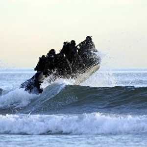 Students in Navy SEALs qualification training navigate the surf off the cost of Coronado