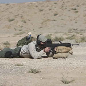 A U. S. Contractor sights in a German G36 assault rifle