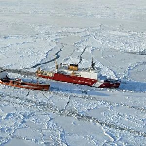 USCG Healy breaks ice around a Russian-flagged tanker south of Nome, Alaska