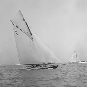 Mrs GA Shenley at the helm of the 8 Metre class Spero (H8). Creator: Kirk & Sons of Cowes