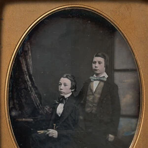 Two Young Men in Bow Ties, One Seated Holding a Book, One Standing, 1850s