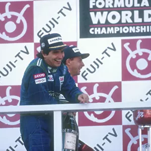 1990 Japanese Grand Prix. Suzuka, Japan. 19-21 October 1990. Nelson Piquet (Benetton Ford) celebrates his 1st position with teammate Roberto Moreno, 2nd position on the podium. Ref-90 JAP 21. World Copyright - LAT Photographic