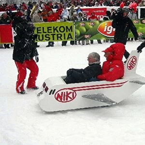 Charity Ski Event: Bernie Ecclestone F1 Supremo takes a ride in a sleigh with Niki Lauda