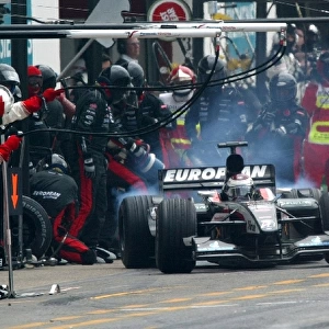 Formula One World Championship: Race retiree Jos Verstappen Minardi Cosworth PS03 makes a pit stop