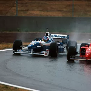 Formula One World Championship: Winner Michael Schumacher Ferrari F310 overtakes Villeneuve