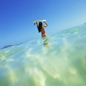 Hawaii, Oahu, Lanikai Beach, Over / Under View Of Woman Holding Surfboard On Head