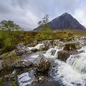 Waterfall on River Coupal and mountain range Buachaille Etive Mor at Glen Coe in Scotland, United Kingdom
