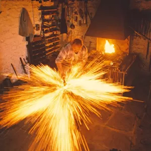 A blacksmith at work in a forge