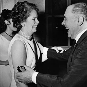 Carlo Ponti and Mrs Charlie Chaplin laughing together during a party at the Savoy Hotel