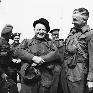 Colour Sergeant J. E. Pardoe (left) tries on a bowler hat in Gibraltar whilst waiting to