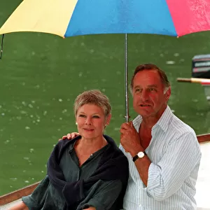 DAME JUDi DENCH & GEOFFREY PALMER (HOLDING UMBRELLA) SEATED IN ROWING BOAT DURING FILMING