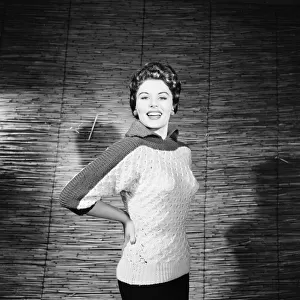 Eunice Gayson, actress and model, poses in a sweater for Sunday Mirror Promotion