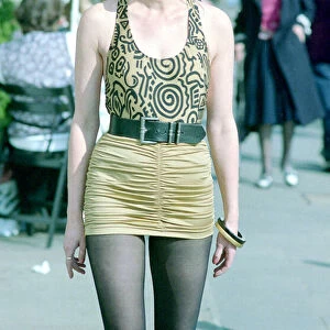 Fashion 1990s Woman walking down the street wearing a mini skirt with a leotard