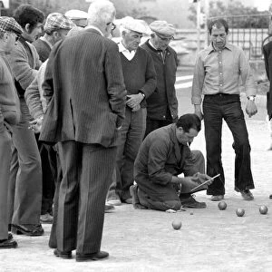 Frenchmen play Boules in the streets of Poussan, France. April 1975 75-2097