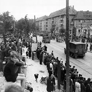 German civilians watch units of the US 7th Armoured Division enter Berlin. 4th July 1945