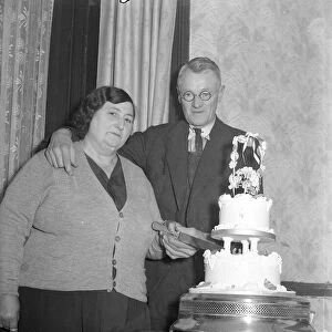 The happy couple cut the wedding cake at the reception 1949