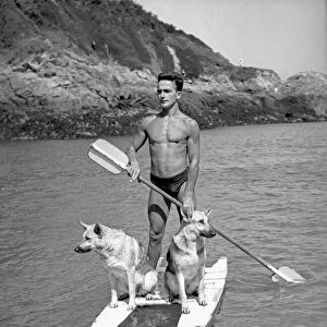 Harry Ibbotson of Fermain Bay in Guernsey on his paddle boat with his two Alsatian dogs