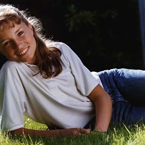 Juliette Carton actress wearing jeans lying in grass